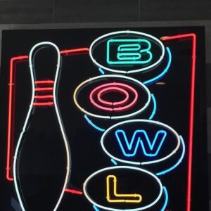 A neon sign that says bowl and bowling.